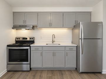 Bridgeport apartment for rent - A kitchen with a stove, oven, sink, and refrigerator.