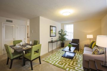 Arlington apartment for rent - A well-lit living room with a dining table and chairs.