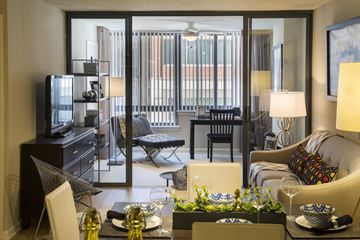 Arlington apartment for rent - A living room with a glass table and chairs.