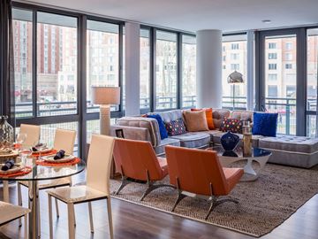 Alexandria apartment for rent - A living room with a glass table and chairs.