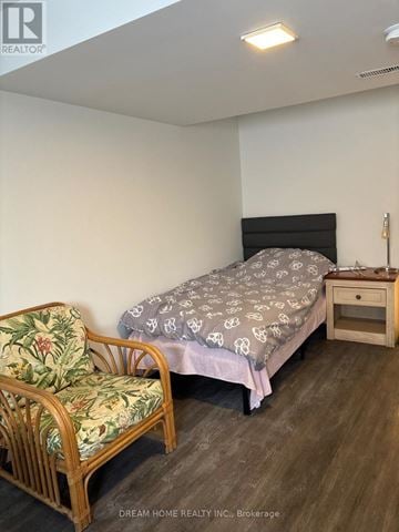 Mississauga (Clarkson) apartment for rent - A bedroom with a bed, chair, and nightstand.