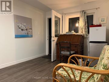 Mississauga (Clarkson) apartment for rent - A room with a bed, chair, and a painting on the wall.