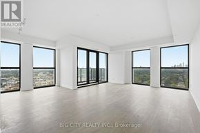 Toronto (Thorncliffe Park) condo for rent - A spacious room with large windows overlooking a cityscape.