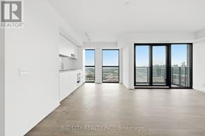 Toronto (Thorncliffe Park) condo for rent - A spacious room with a view of the city through large windows.