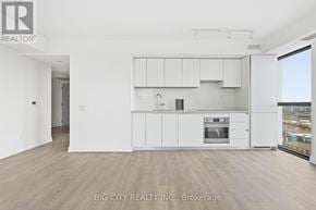 Toronto (Thorncliffe Park) condo for rent - A white kitchen with a stove top oven and cabinets.