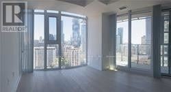 Toronto (Church-Yonge Corridor) condo for rent - A large empty room with a view of the city outside the windows.