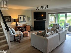 Collingwood townhouse for rent - A living room with a fireplace and a couch.