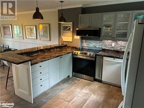 Collingwood townhouse for rent - A kitchen with a black granite countertop and white cabinets.