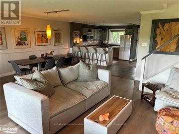 Collingwood townhouse for rent - A living room with a couch, coffee table, and a painting on the wall.
