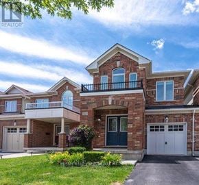 Burlington (Alton) apartment for rent - A large, well-maintained house with a brick facade and a balcony.