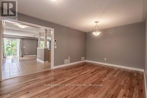 Burlington (Alton) apartment for rent - A spacious room with wooden flooring and a large window.