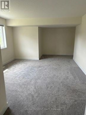 Milton (Cb Cobban) apartment for rent - A room with a carpeted floor and white walls.
