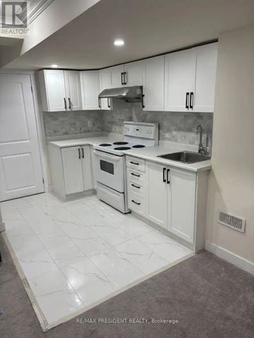 Milton (Cb Cobban) apartment for rent - A white kitchen with a marble floor.
