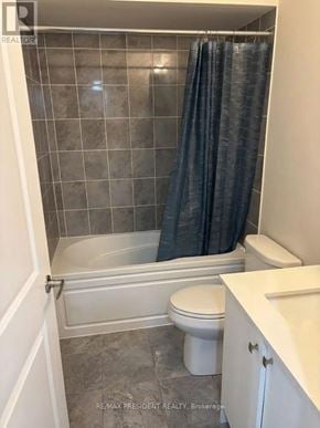 Milton (Cb Cobban) apartment for rent - A bathroom with a white toilet and a bathtub with a black shower curtain.