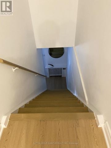 Mississauga (Port Credit) multi-family for rent - A staircase with wooden steps and white walls.