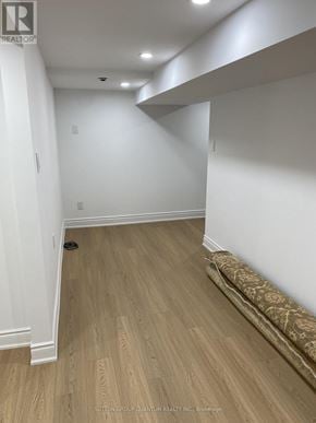 Mississauga (Port Credit) multi-family for rent - A hallway with wood flooring and white walls.