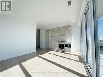 Mississauga (City Centre) condo for rent - A spacious, well-lit kitchen area with a large island and modern appliances.