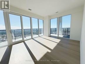Mississauga (City Centre) condo for rent - A sunny room with a view of the cityscape.