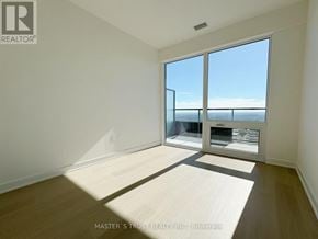 Mississauga (City Centre) condo for rent - A room with a large window overlooking the ocean.