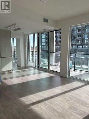 Brampton (Fletcher's Creek South) condo for rent - A spacious room with a sliding glass door leading to a balcony.