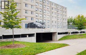 Kitchener condo for rent - A large building with a parking garage underneath it.