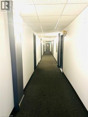 Kitchener condo for rent - A long hallway with doors on both sides.
