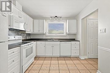 Oakville (Oo Old Oakville) apartment for rent - A kitchen with white cabinets and appliances.