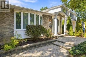 Oakville (Oo Old Oakville) apartment for rent - A house with a stone wall and a sign that says REALTOR.