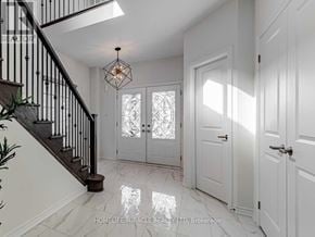 Oshawa (Taunton) apartment for rent - A hallway with white doors and a staircase with a metal railing.