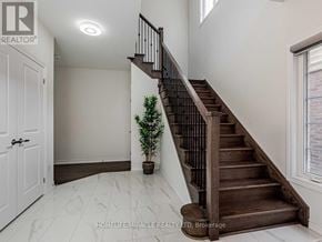 Oshawa (Taunton) apartment for rent - A white door is on the left of a staircase with a plant on the landing.