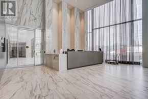 Mississauga (City Centre) condo for rent - A reception area with a marble floor and a large window with curtains.