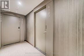 Mississauga (City Centre) condo for rent - A hallway with elevator doors numbered 6102 and 6103.
