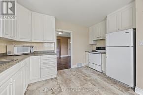 Blandford-Blenheim apartment for rent - A kitchen with white cabinets and appliances.