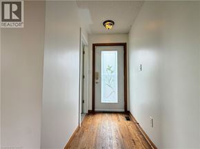 Cambridge apartment for rent - A hallway with a wooden floor and a glass door.