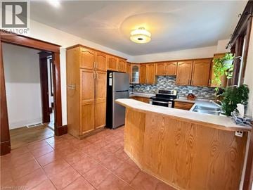 Cambridge apartment for rent - A kitchen with wooden cabinets and a tiled floor.
