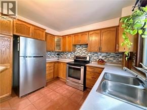 Cambridge apartment for rent - A kitchen with a stainless steel refrigerator, oven, and sink.