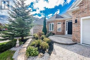 Caledon (Caledon East) apartment for rent - A house with a black front door and a white garage door.