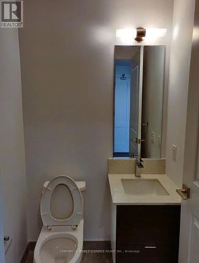 Mississauga (Fairview) condo for rent - A bathroom with a toilet, sink and mirror.