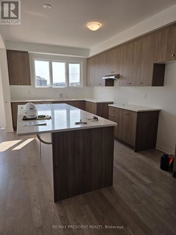 Kitchener apartment for rent - A modern kitchen with a large island and wooden cabinets.