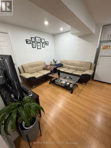 Kitchener apartment for rent - A living room with a tan couch and a black coffee table.