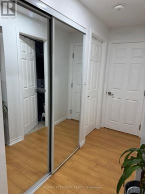 Kitchener apartment for rent - A hallway with white doors and wooden floors.