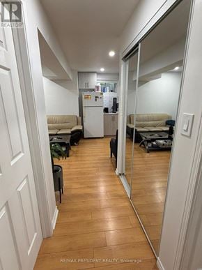 Kitchener apartment for rent - A hallway with a mirror on the wall and a dog on the floor.