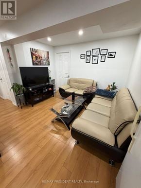 Kitchener apartment for rent - A living room with a beige couch and a black television.