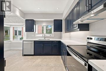 Oakville (Br Bronte) townhouse for rent - A modern kitchen with black cabinets and stainless steel appliances.