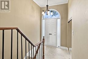 Oakville (Br Bronte) townhouse for rent - A hallway with a white door and a staircase with a wooden railing.