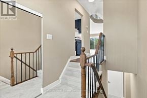 Oakville (Br Bronte) townhouse for rent - A staircase with a wooden handrail and a glass door leading to another room.