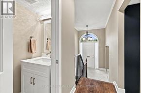 Oakville (Br Bronte) townhouse for rent - A bathroom with a white sink and a wooden staircase.