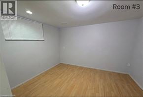 Waterloo apartment for rent - A room with wooden flooring and a window with blinds.
