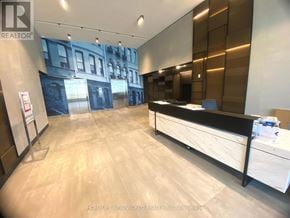 Markham (Unionville) condo for rent - A realtor office with a reception desk and a wall mural of a building.