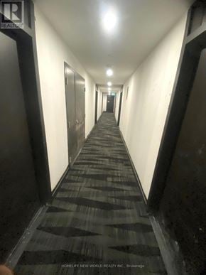 Markham (Unionville) condo for rent - A long hallway with a carpeted floor and doors on both sides.